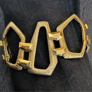 Textured geometric gold tone stretch statement bracelet